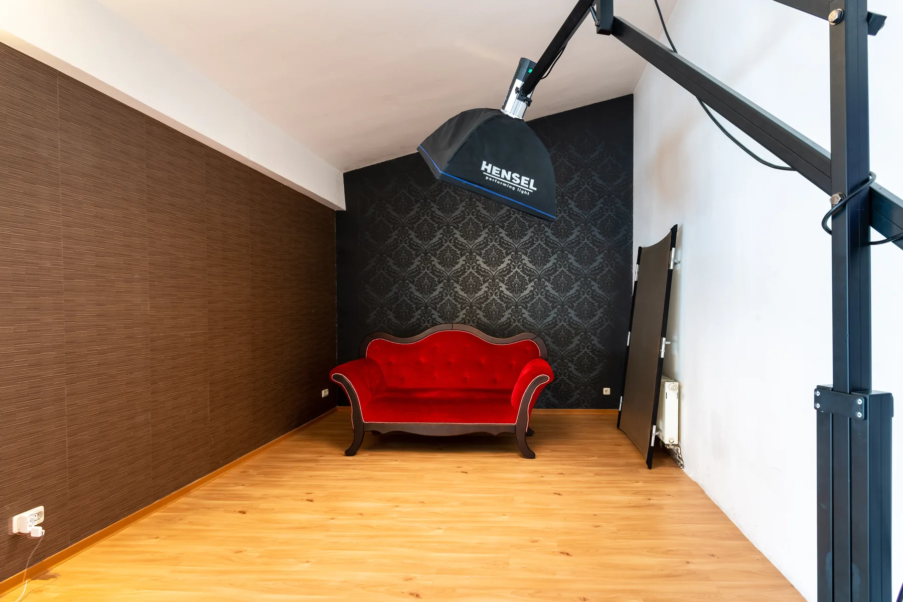 Set with red sofa and dark background